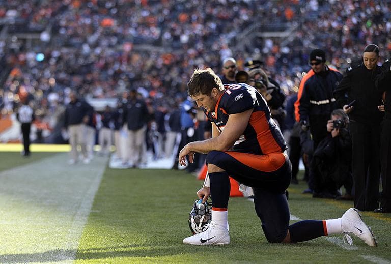 Denver Broncos quarterback Tim Tebow prays in the end zone before the start of an NFL football game against the Chicago Bears. (AP)