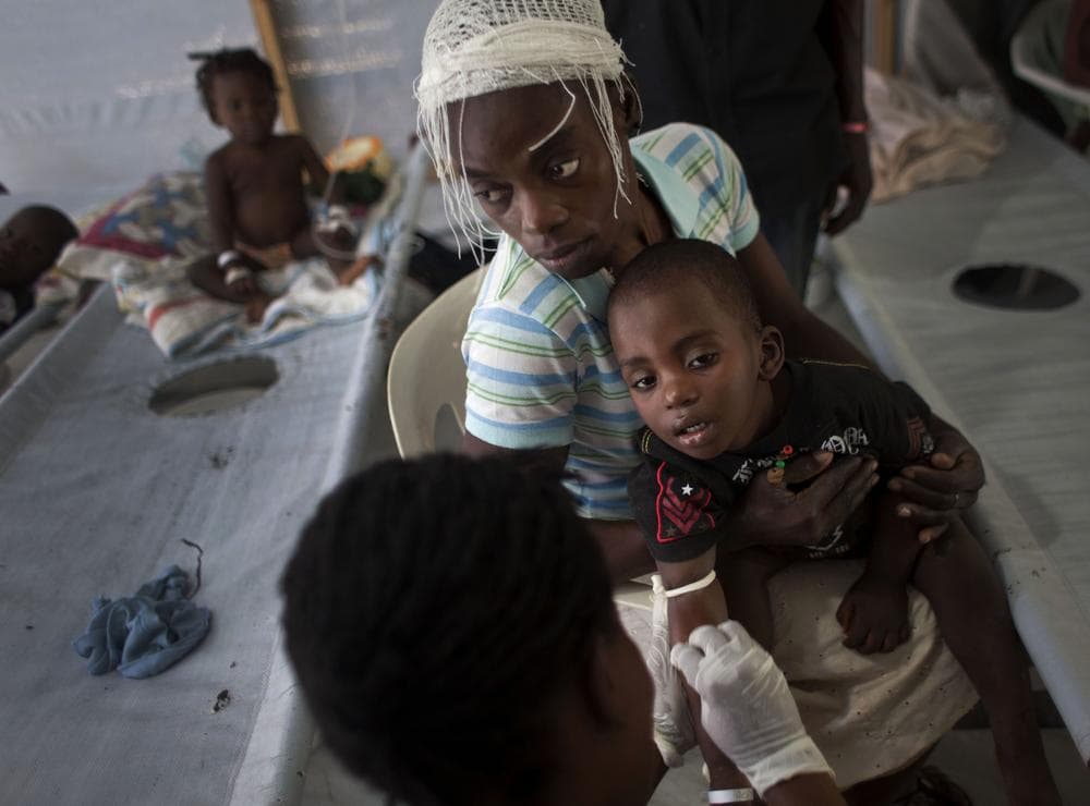 A woman holds her sick child as he receives treatment for cholera at a Doctors Without Borders, MSF, cholera clinic in Port-au-Prince, Haiti. (AP)