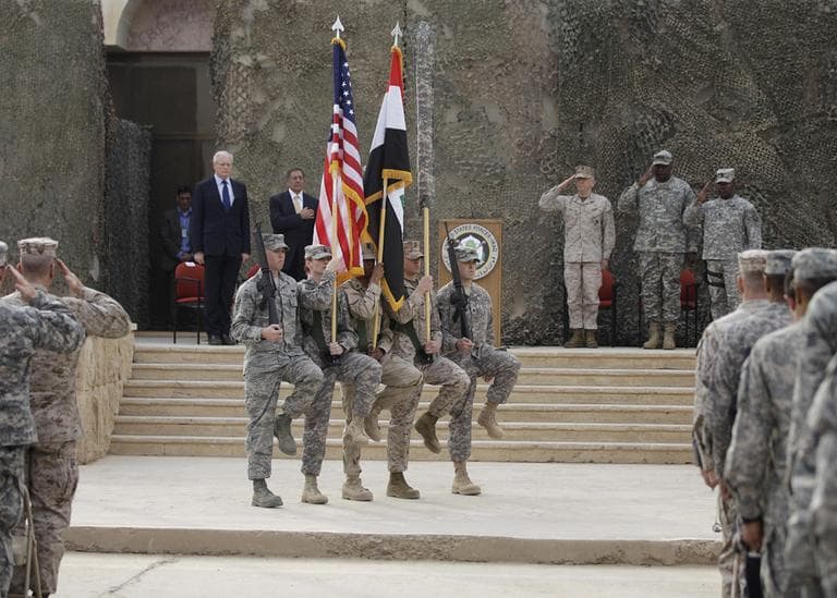 The US flag, Iraq flag, and the US Forces Iraq colors are seen before they are carried in during ceremonies marking the end of US military mission in Baghdad, Iraq, Thursday, Dec. 15, 2011. After nearly nine years, 4,500 American dead, 32,000 wounded and more than $800 billion, U.S. officials formally shut down the war in Iraq a conflict that U.S. Defense Secretary Leon Panetta said was worth the price in blood and money, as it set Iraq on a path to democracy. (AP)