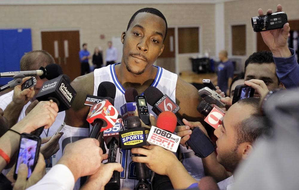 Orlando Magic's Dwight Howard answers questions from reporters during the Monday's media day. (AP)