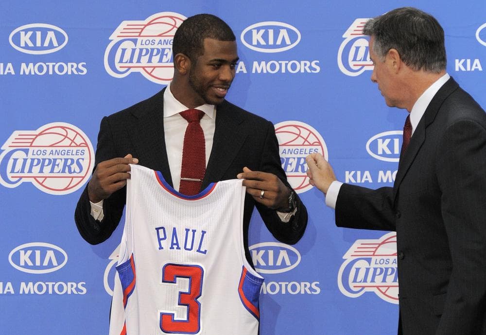 Los Angeles Clippers vice president of basketball operations Neil Olshey with newly acquired point guard Chris Paul during a news conference on Thursday. (AP)