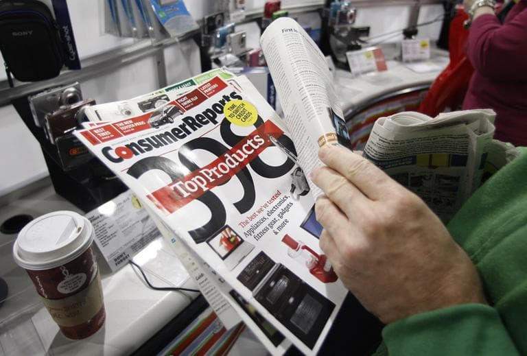 A shopper looks through his Consumer Reports magazine while shopping for a digital camera at Best Buy on Black Friday, Nov. 27, 2009, in South Portland , Maine. (AP)