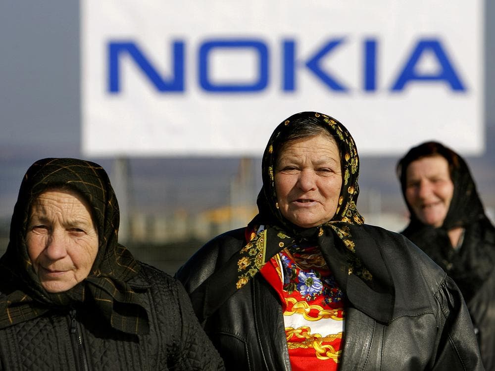 Romanian villagers walk outside the new Nokia factory in Jucu, central Romania, after the official opening in 2008. (AP)
