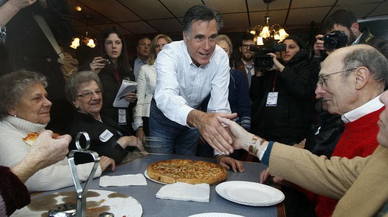 Republican presidential candidate Mitt Romney shakes hands with patrons while campaigning at Village Pizza in Newport, N.H., Wednesday. (AP)