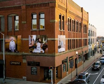 Meehan&#039;s portraits hang from a building at 214 Main Street in Brockton, Mass. (Courtesy of Mary Beth Meehan)