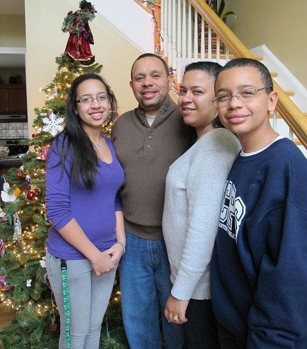 The Montero family, from left: Victoria 14; Sgt. Jose Montero; Darlease; and Gregory, 12, in their New Bedford home (Monica Brady-Myerov/WBUR)