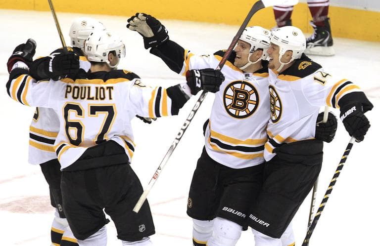 Boston Bruins&#039; Dennis Seidenberg, second from right, celebrates with teammates after scoring the game-winning goal during overtime Wednesday night. (AP)