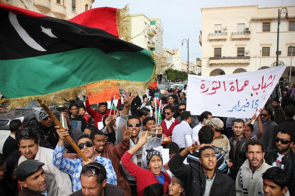 Men chant slogans during a protest in Benghazi, Libya. Arabic writing on the banner, right, reads &quot;Libyan youth will protect the revolution.&quot; (AP)