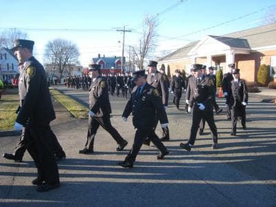 Peabody firefighters walk to the wake of James Rice Thursday, Dec. 29. Rice died fighting a fire in Peabody last Friday. (Nancy Eve Cohen for WBUR)
