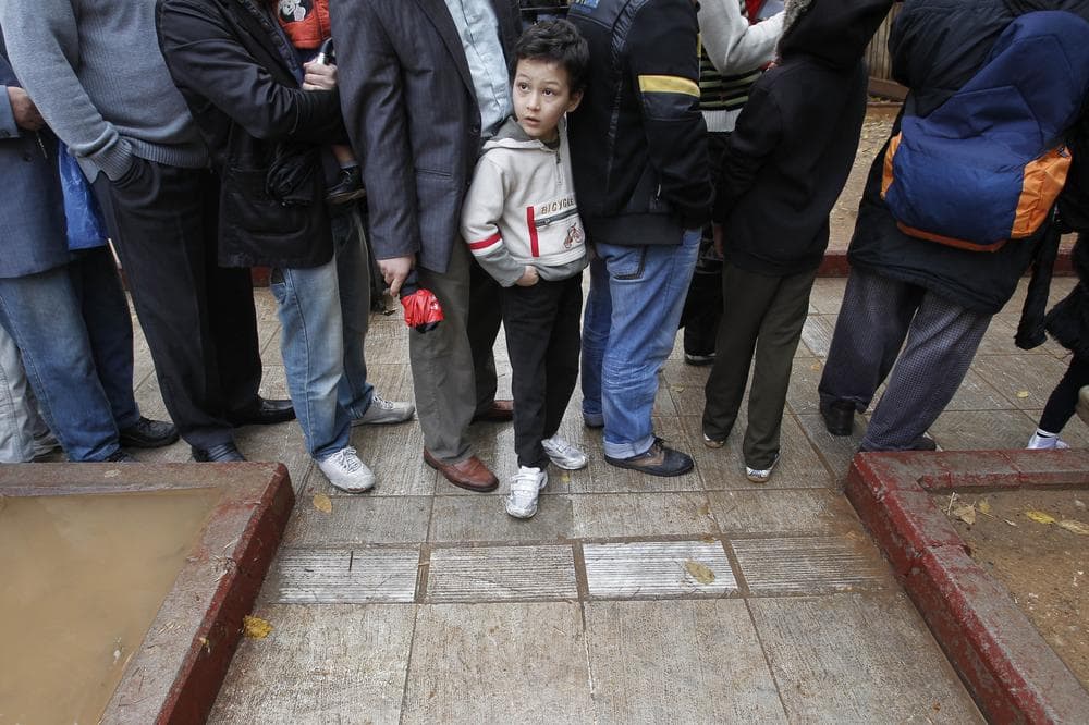 A child waits in line to receive food distributed from the Greek Orthodox Church in Athens, on Thursday. The leader of Greece&#039;s Orthodox Church is promising to boost its campaign to provide free meals to the poor and homeless amid the country&#039;s deepening financial crisis.(AP)