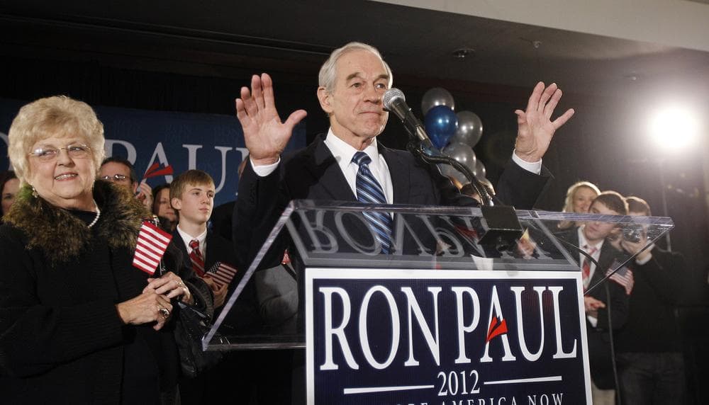 Republican presidential candidate Rep. Ron Paul, R-Texas, tries to quiet the crowd at his caucus night rally, Tuesday in Ankeny, Iowa. (AP)
