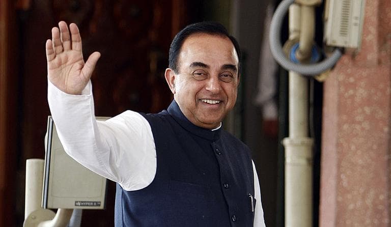 Subramanian Swamy gestures to the media as he enters the Indian Parliament in 2010. (AP Photo/ Mustafa Quraishi)