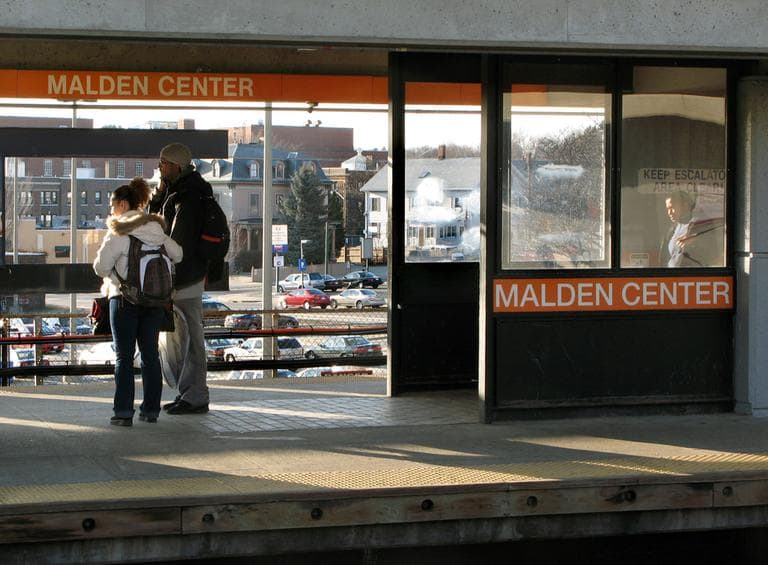 Riders wait on the platform of the MBTA station in Malden in March 2009. (AP)