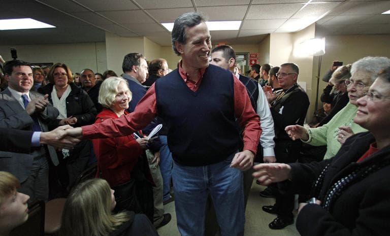Former Pennsylvania Sen. Rick Santorum shakes hands during a campaign stop in Brentwood, N.H., on Wednesday. (AP)