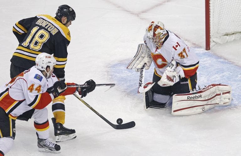 Calgary Flames goalie Leland Irving drops to his pads to make a save on a shot by Boston Bruins right wing Nathan Horton during Thursday night&#039;s game. (AP)