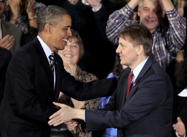 President Obama shakes hands with Richard Cordray at Shaker Heights High School, in Shaker Heights, Ohio, on Wednesday. (AP)