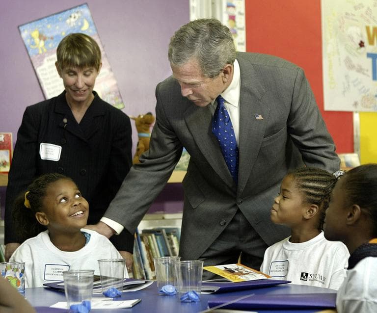 President Bush leans over to speak with third grader Tameron Clark as he tours a tutoring center at Kirkpatrick Elementary School in Nashville, Tenn., in 2003. (AP)