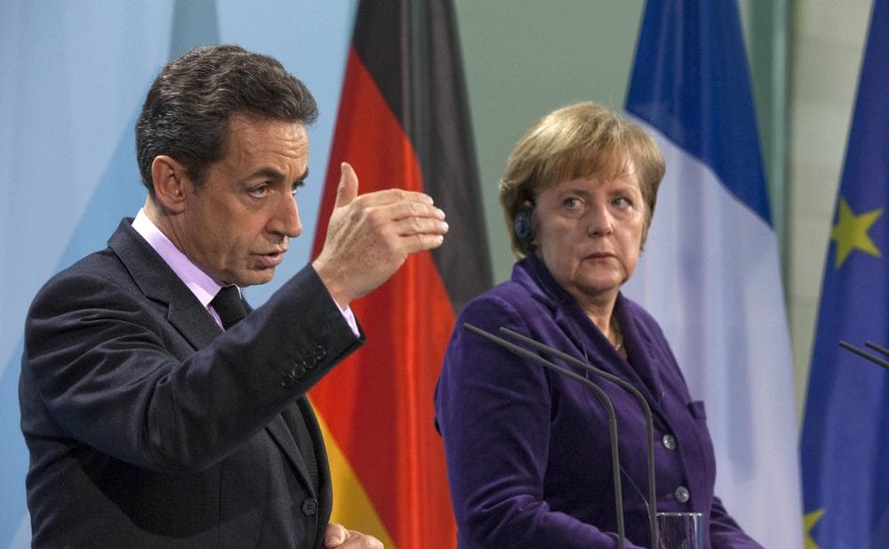 German Chancellor Angela Merkel, right, and French President Nicolas Sarkozy, left, stand next to each other during a news conference at the Chancellery in Berlin, Germany, Monday. (AP)