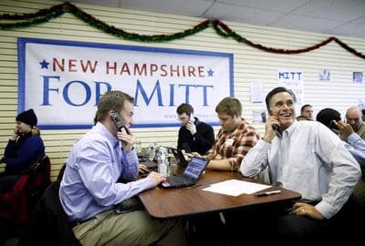 Former Massachusetts Gov. Mitt Romney sits with volunteers and calls likely voters ahead of Tuesday's primary election on Monday. (AP)