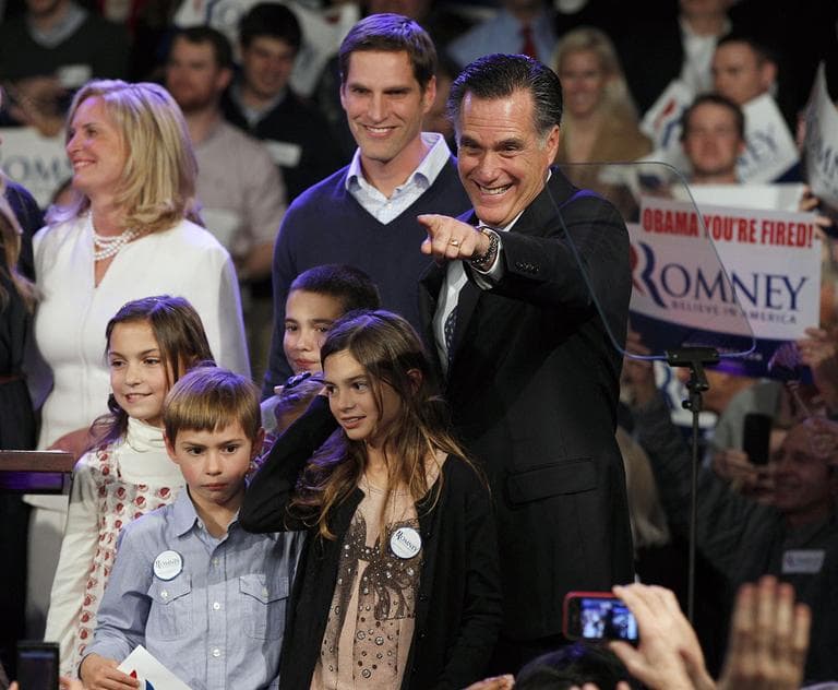 Former Massachusetts Gov. Mitt Romney, surrounded by his family, points towards supporters at the New Hampshire primary night victory party in Manchester, N.H., Tuesday. (AP)
