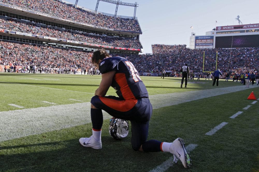 Denver Broncos quarterback Tim Tebow (15) kneels and prays before the start of an NFL football game against the Chicago Bears in December. (AP)