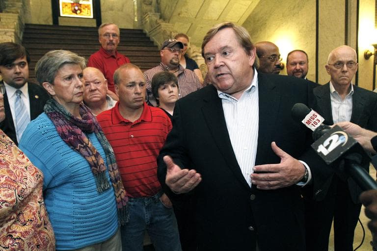 Rep. Bobby Moak, D-Bogue Chitto, right, stands with relatives including Betty Ellis, mother of murdered Tammy Ellis Gatlin left, and gunshot survivor Randy Walker, both victims of recently pardoned killer David Gatlin, to call for an end to such end-of-tenure pardons by outgoing governors, Monday, Jan 9, 2012 at the Capitol in Jackson, Miss. Outgoing Gov. Haley Barbour's pardon of at least four convicted killers who worked as inmate trusties at the Governor's Mansion, including a man who was denied parole less than two weeks ago has outraged victims' relatives as well as a number of Democratic lawmakers. (AP)