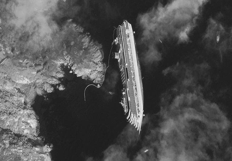 This Jan. 17, 2012 satellite image provided by DigitalGlobe shows the luxury cruise ship Costa Concordia, which ran aground on Friday, Jan. 13, lying on its starboard side just off the tiny Tuscan island of Isola del Giglio, Italy. As the ship keeps shifting on its rocky ledge, many have raised the prospect of a possible environmental disaster if the 2,300 tonnes of fuel on the half-submerged cruise ship leaks. Satellites are used to monitor the area while authorities are preparing to remove the fuel from inside the vessel. (AP Photo/DigitalGlobe)