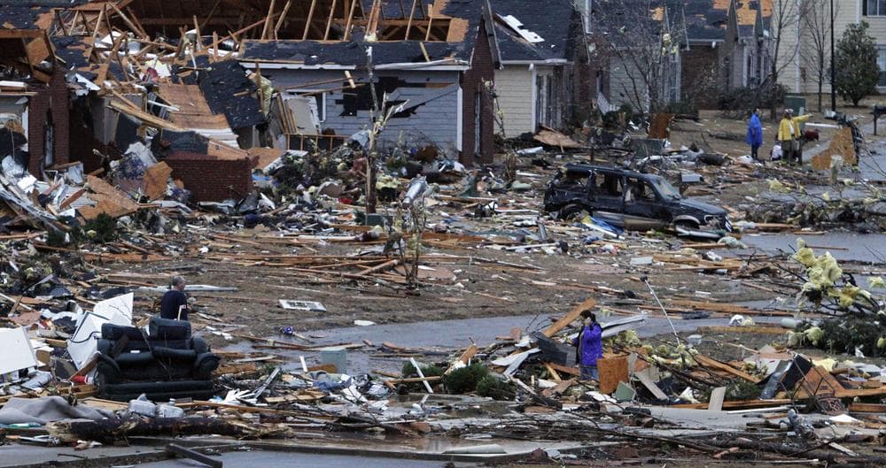 Residents walk around through the debris of their neighborhood after a tornado ripped through the Trussville, Ala. area in the early hours of Monday. (AP)