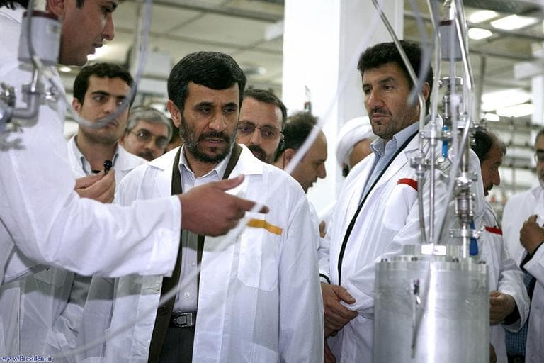 In this photo released by the Iranian President's Office, Iranian President Mahmoud Ahmadinejad, center, listens to a technician during his visit of the Natanz Uranium Enrichment Facility  April 8, 2008. During a tour of the Natanz facility in ceremonies marking the second anniversary of Iran's first enrichment of uranium, Ahmadinejad announced the start of work on installing the 6,000 new centrifuges. Later in a nationally televised speech, he announced the testing of the new, more effective device. (AP)