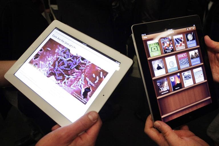 Apple employees demonstrate interactive features of iBooks 2 for iPad, Thursday, Jan. 19, 2012 in New York. IBooks 2 will be able to display books with videos and other interactive features. (AP)