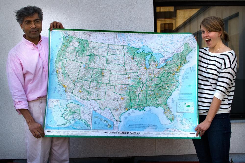 Here &amp; Now producers Hitesh Hathi (left) and Jill Ryan hold Dave Imus&#039; massive map of the United States. (Jesse Costa/Here &amp; Now)