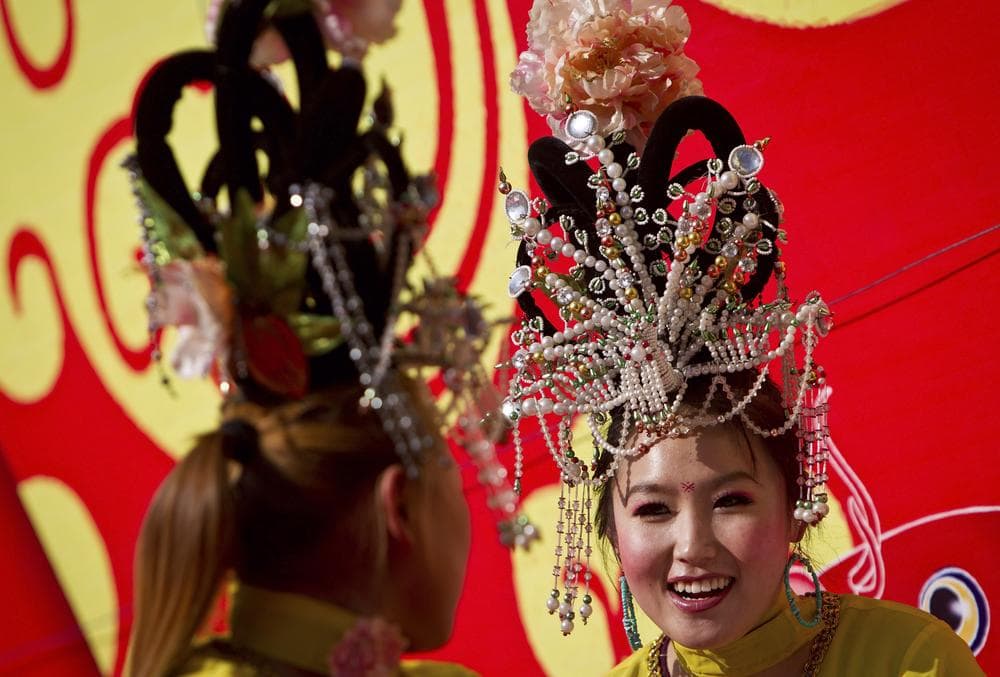 Chinese female performers chat near the stage before their show at the Longtan Park&#039;s temple fair during the Chinese New Year celebrations in Beijing, China, Wednesday. (AP)