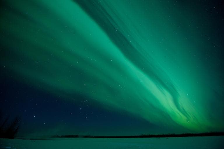 In this photo taken Monday, Jan. 23, 2012, the skies over the frozen Susitna River near Talkeetna, Alaska are lit up by a display of the northern lights, or Aurora Borealis.  A common occurrence in northern climates, the aurora was enhanced in this display by solar flares in the days preceding the event.  (AP)