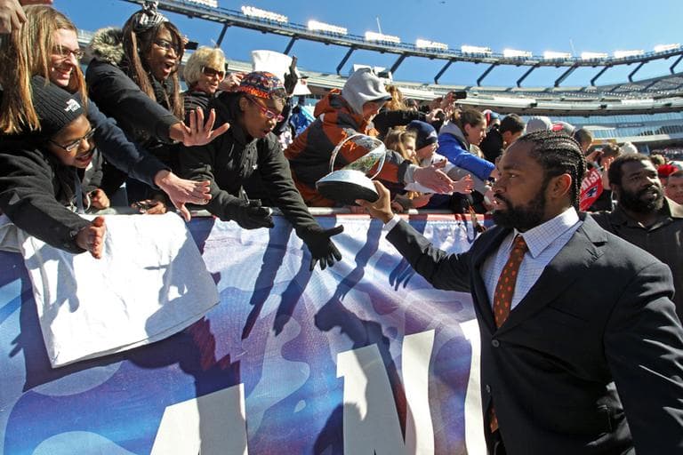 Patriots linebacker Jerod Mayo, front right, displays the Lamar Hunt Trophy to fans as he exits the stadium following a sendoff rally in Foxborough, Sunday. (AP)