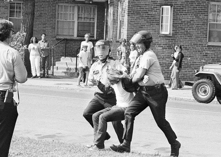Police take an unidentified youth into custody following stoning of school buses after they had left South Boston High School on the second day of court-ordered busing in Boston, Sept. 14, 1974. (AP)