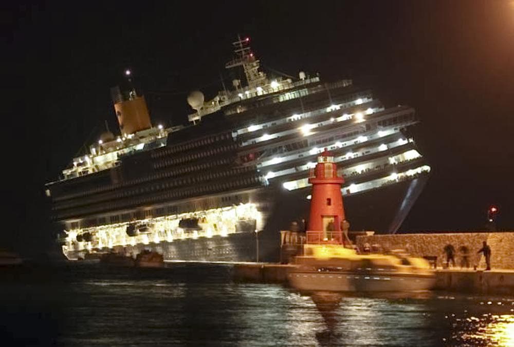 The luxury cruise ship Costa Concordia leans after it ran aground off the coast of Isola del Giglio island, Italy, gashing open the hull. (AP)