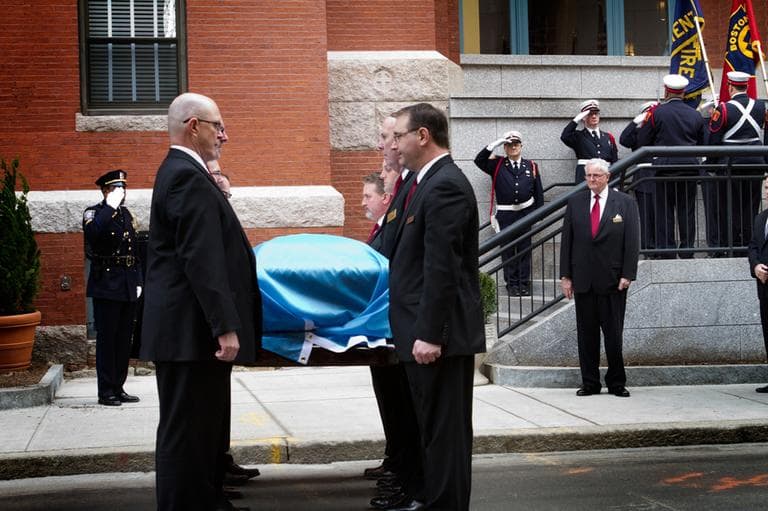 Pallbearers carry Kevin White&#039;s casket into St. Cecilia Church. (Jesse Costa/WBUR)