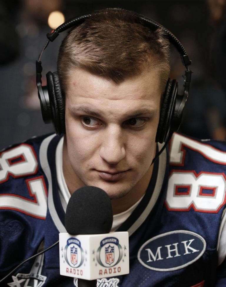 Patriots tight end Rob Gronkowski does an interview during a news conference on Wednesday. The &#039;MHK&#039; on the right side of his football jersey are the initials of Patriots&#039; owner Robert Kraft&#039;s late wife, Myra Hiatt Kraft. (AP)