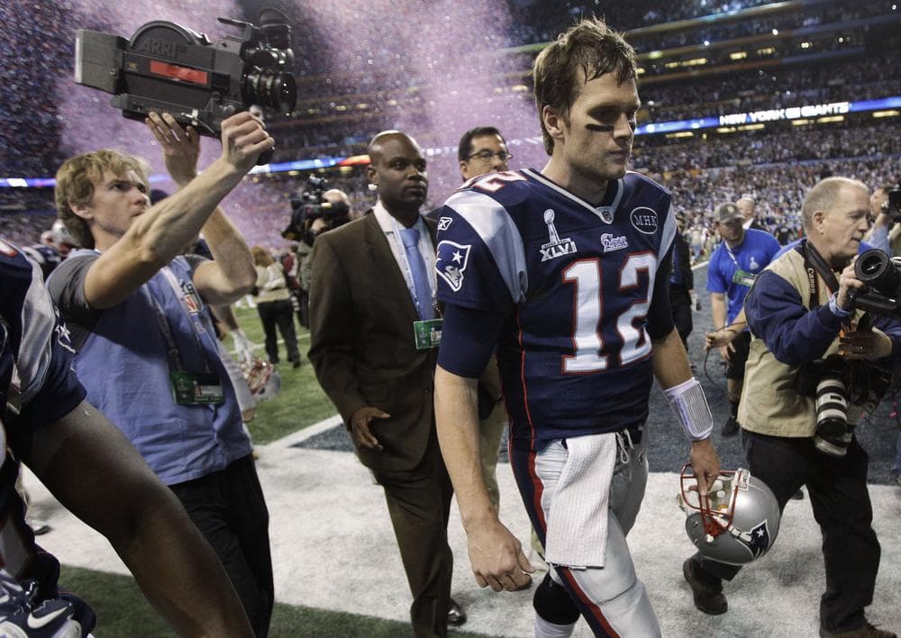 Patriots quarterback Tom Brady walks off the field after the Patriots&#039; 21-17 loss to the Giants. (AP)