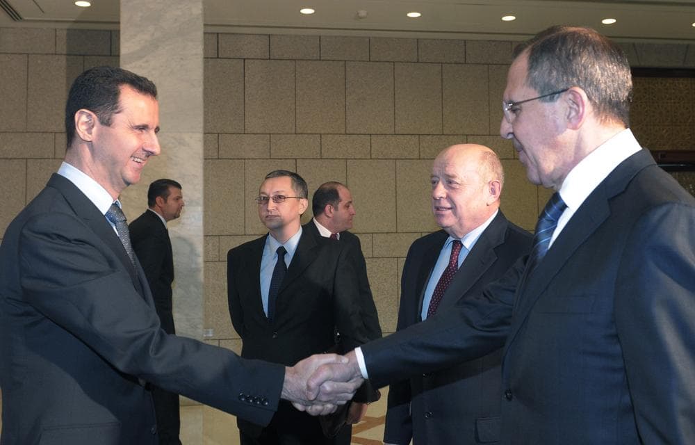 Syrian President Bashar Assad, left, shakes hands with Russian Foreign Minister Sergey Lavrov, right, in Damascus, Syria Tuesday. (AP)