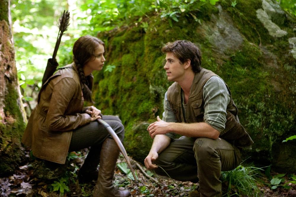 Jennifer Lawrence portrays Katniss Everdeen, left, and Liam Hemsworth portrays Gale Hawthorne in a scene from &quot;The Hunger Games.&quot; (AP/Lionsgate, Murray Close)