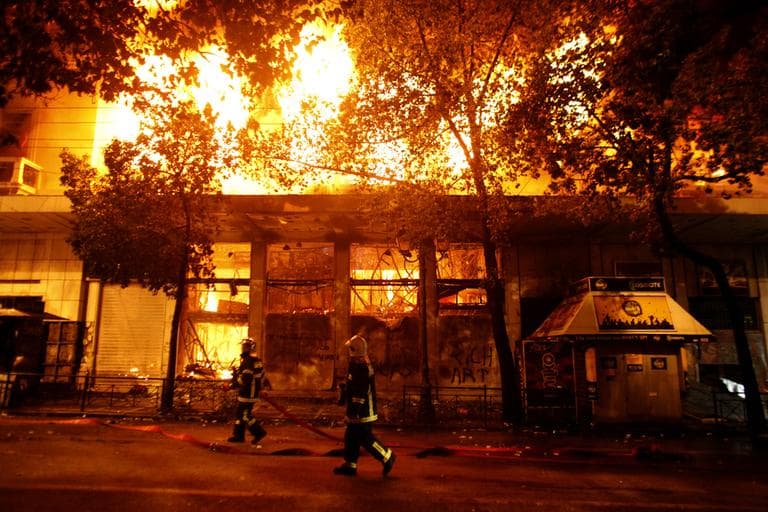 A cinema burns in Athens, Sunday, Feb. 12, 2012. Riots engulfed central Athens and at least 10 buildings went up in flames in mass protests late Sunday. (AP)