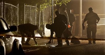 Boston Police detectives search for evidence after a pre-dawn shooting Tuesday, Sept. 28, 2010, where five people, including a toddler, were shot in the Mattapan neighborhood of Boston. (AP)
