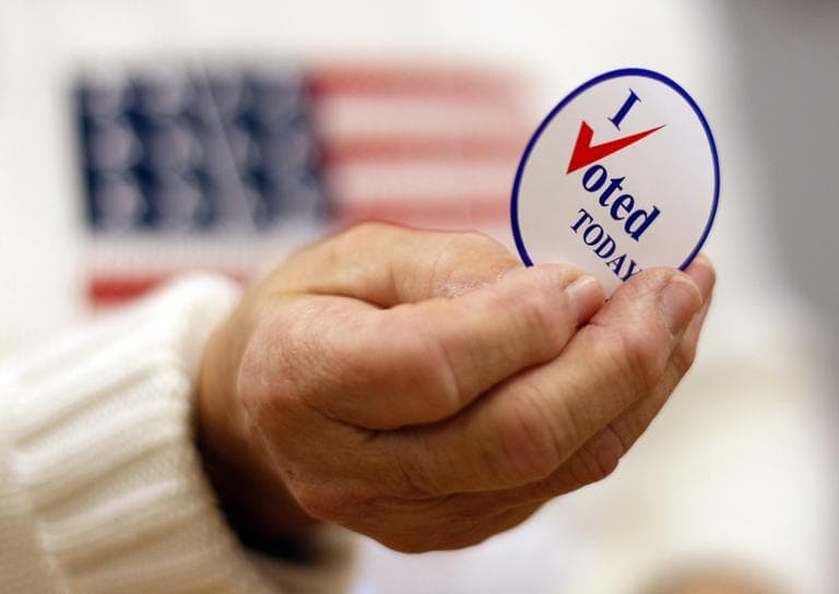 A sticker is handed to a voter on Election Day, Tuesday, Nov. 2, 2010, in Waterville, Maine. (AP)