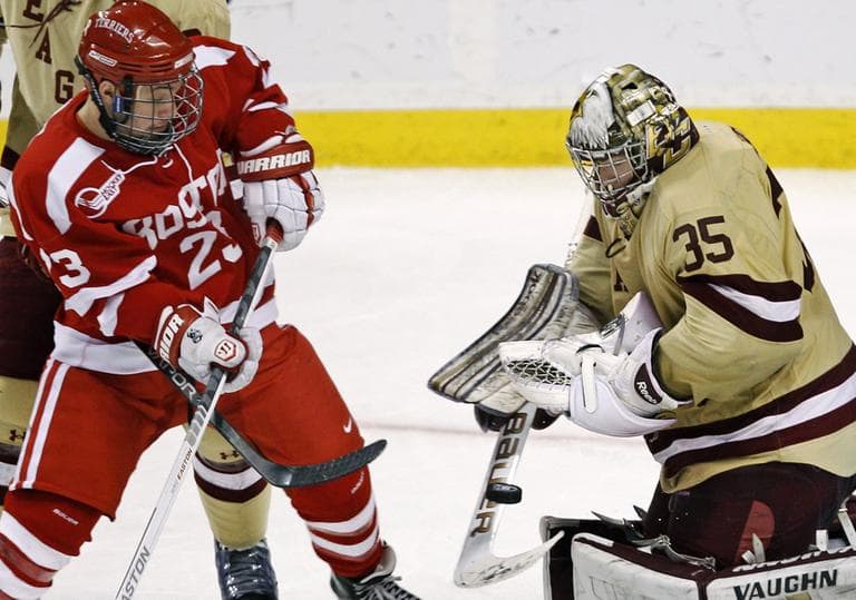 Boston College goalie Parker Milner, right, makes as save as Boston University forward Cason Hohmann looks for the rebound during overtime of the Beanpot tournament championship hockey game in Boston, Monday. (AP)