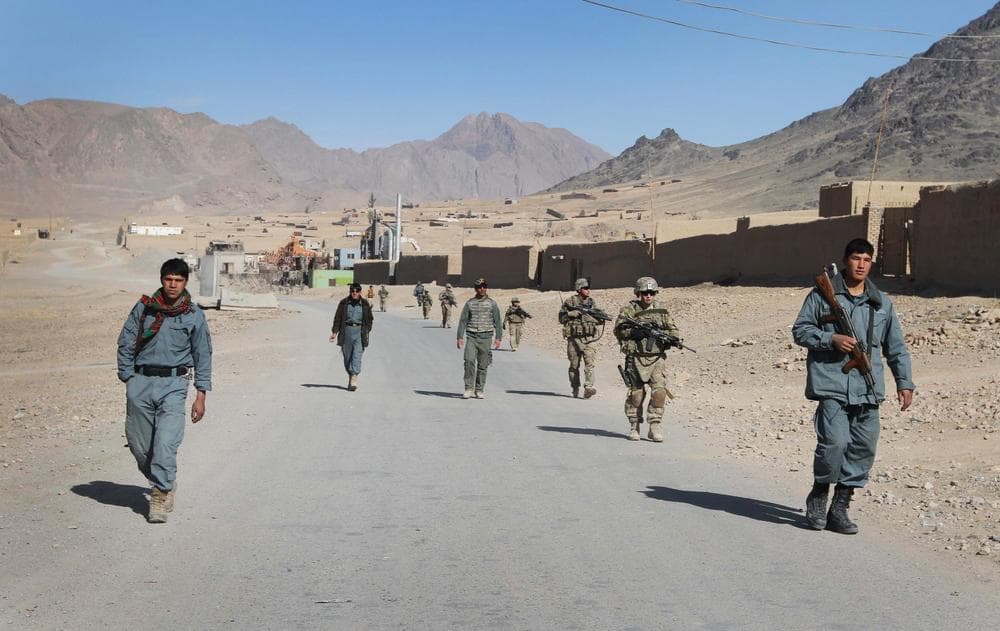Afghan policemen walk ahead of the U.S. soldiers with the NATO- led International Security Assistance Force (ISAF) during a foot patrol in Kandahar, south of Kabul, Afghanistan. (AP)