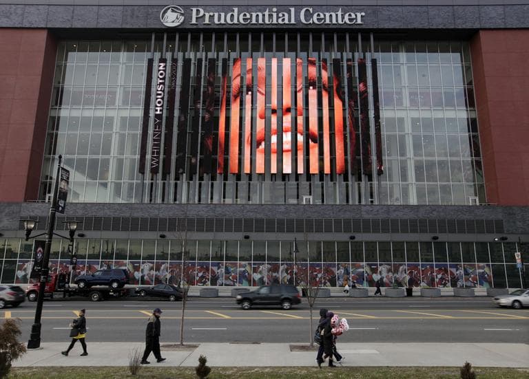 People walk past, a large image of Whitney Houston displayed on the side of the Prudential Center in Newark, N.J., Tuesday, Feb. 14, 2012. (AP)