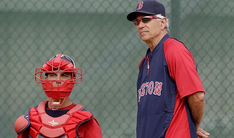 Boston Red Sox manager Bobby Valentine, right, eyes a pitch during a workout with pitchers and catchers. (AP)