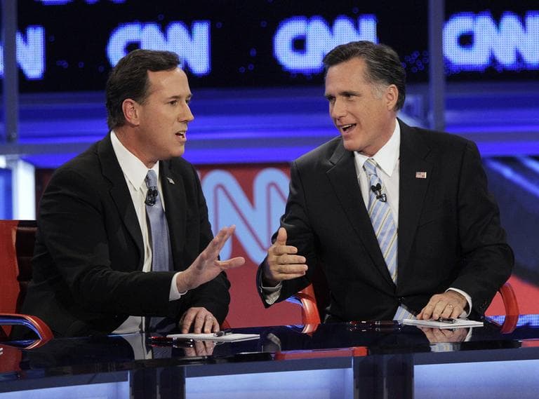 Republican presidential candidates, former Massachusetts Gov. Mitt Romney, right, and former Pennsylvania Sen. Rick Santorum argue a point during a Republican presidential debate Wednesday in Mesa, Ariz. (AP)