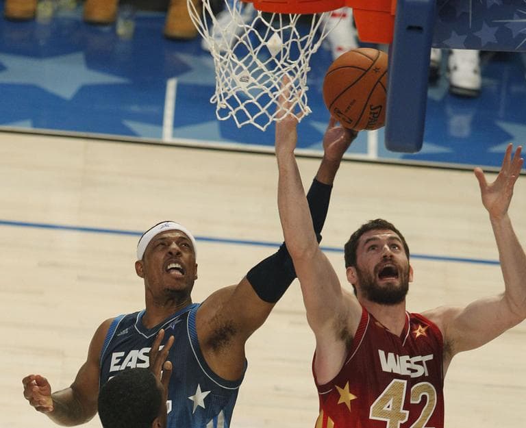 Western Conference's Kevin Love (42), of the Minnesota Timberwolves and Eastern Conference All-Star Paul Pierce (34), of the Celtics go after a rebound. (AP)